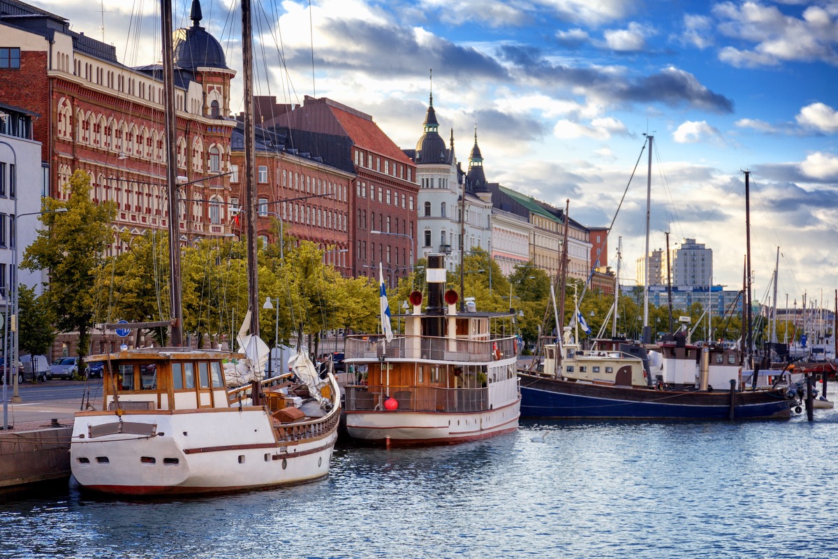 Helsinki harbour promenade with historic wooden boats and the Art Nouveau facades of Katajanokka